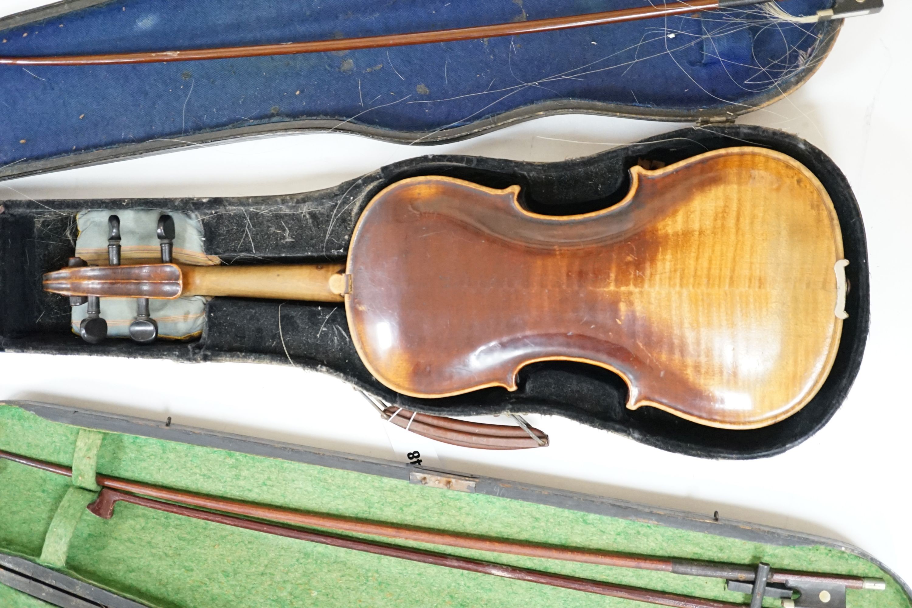 A 19th century 3/4 size violin, cased with 2 bows and 1 other German violin